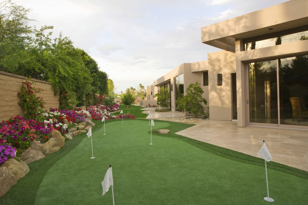 View of mini golf course in garden by luxury house