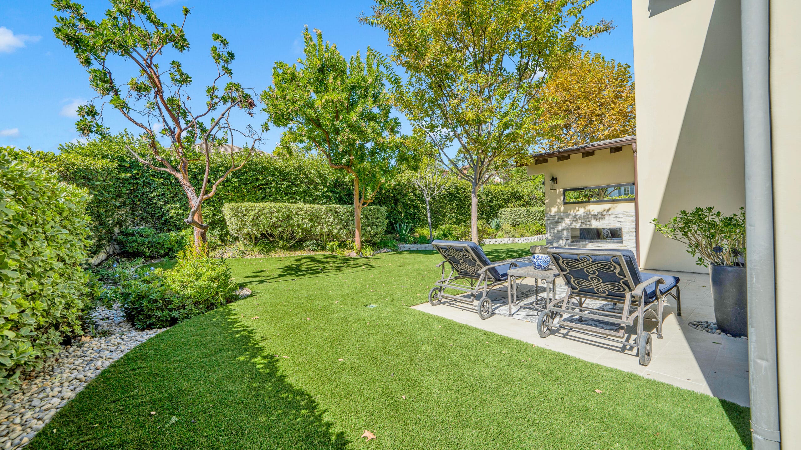 Calabasas backyard artificial turf install with lounge chairs and an outdoor fireplace